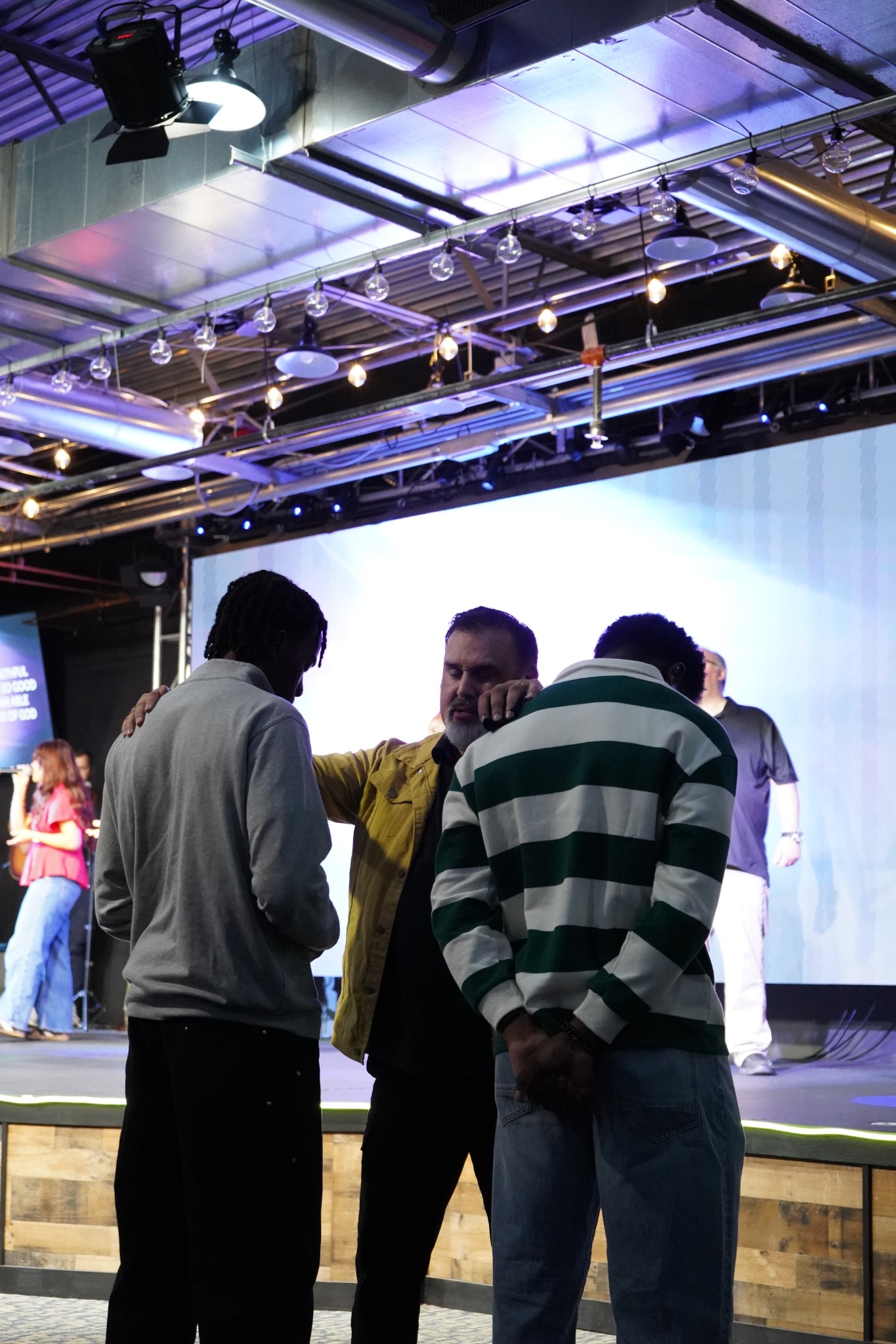 Prayer and encouragement together at the front of the sanctuary.