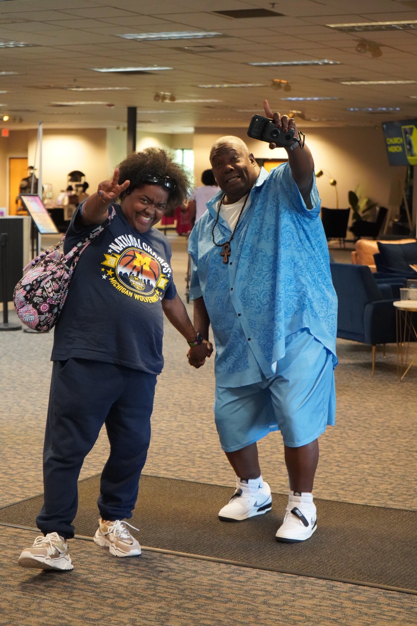 Two smiling adults greeting the camera at church.